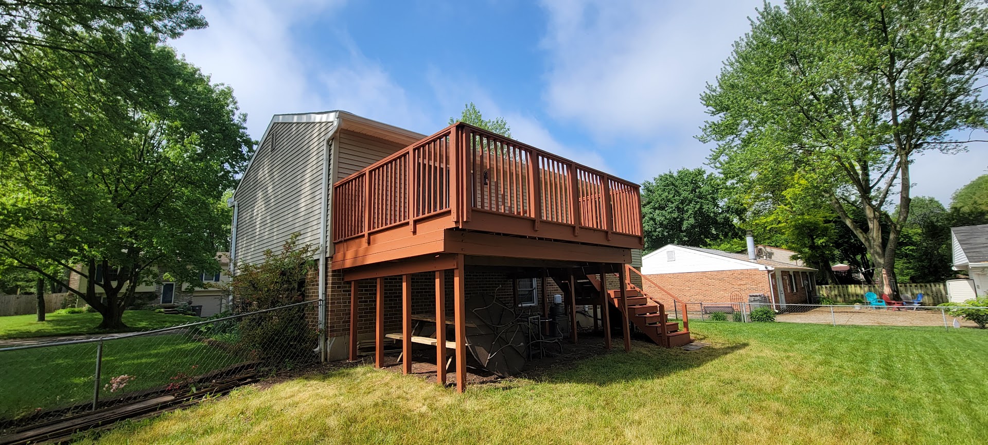 Stained deck on the rear of a multi-story home.